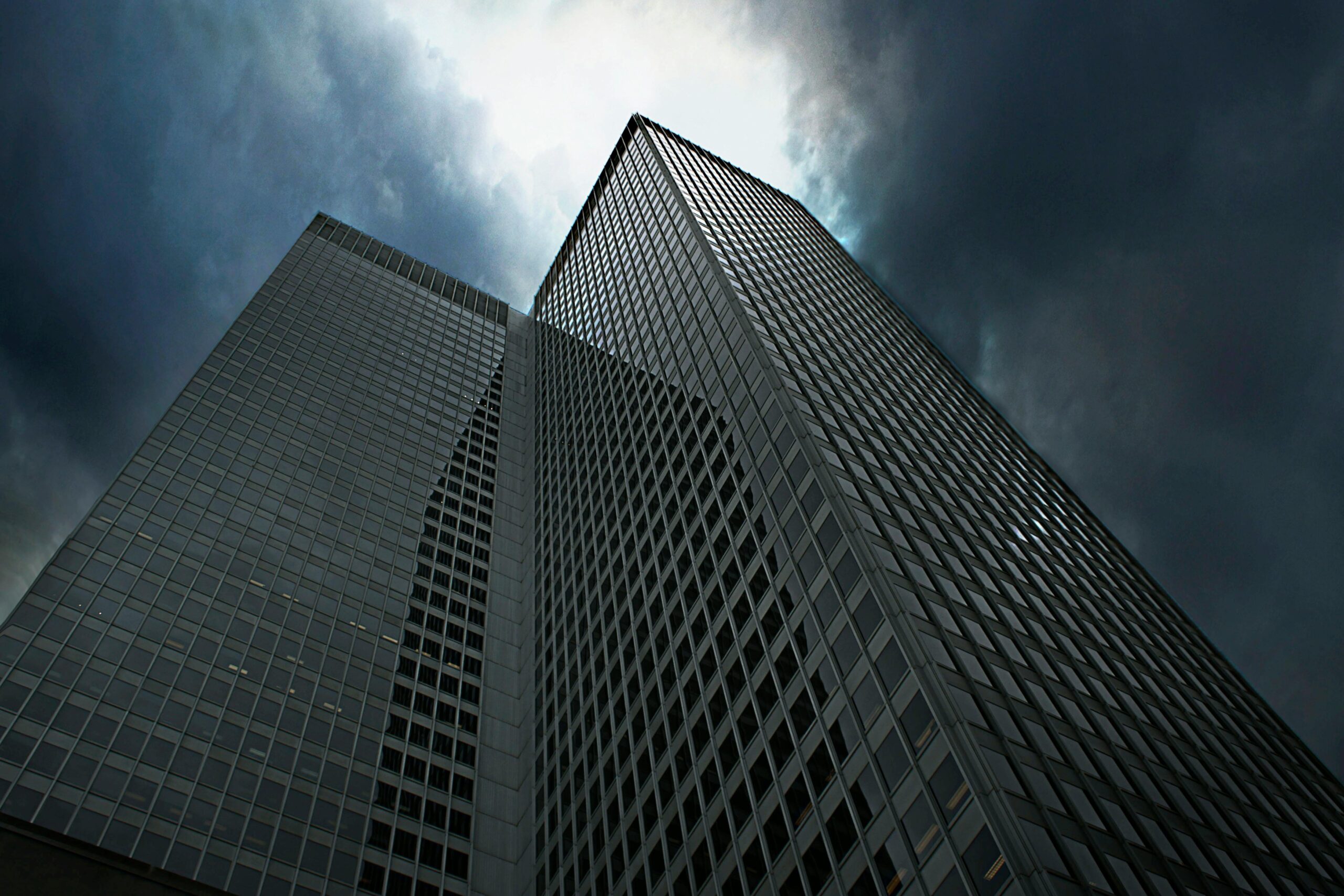 Dramatic view of towering skyscrapers in Montreal with ominous clouds overhead.